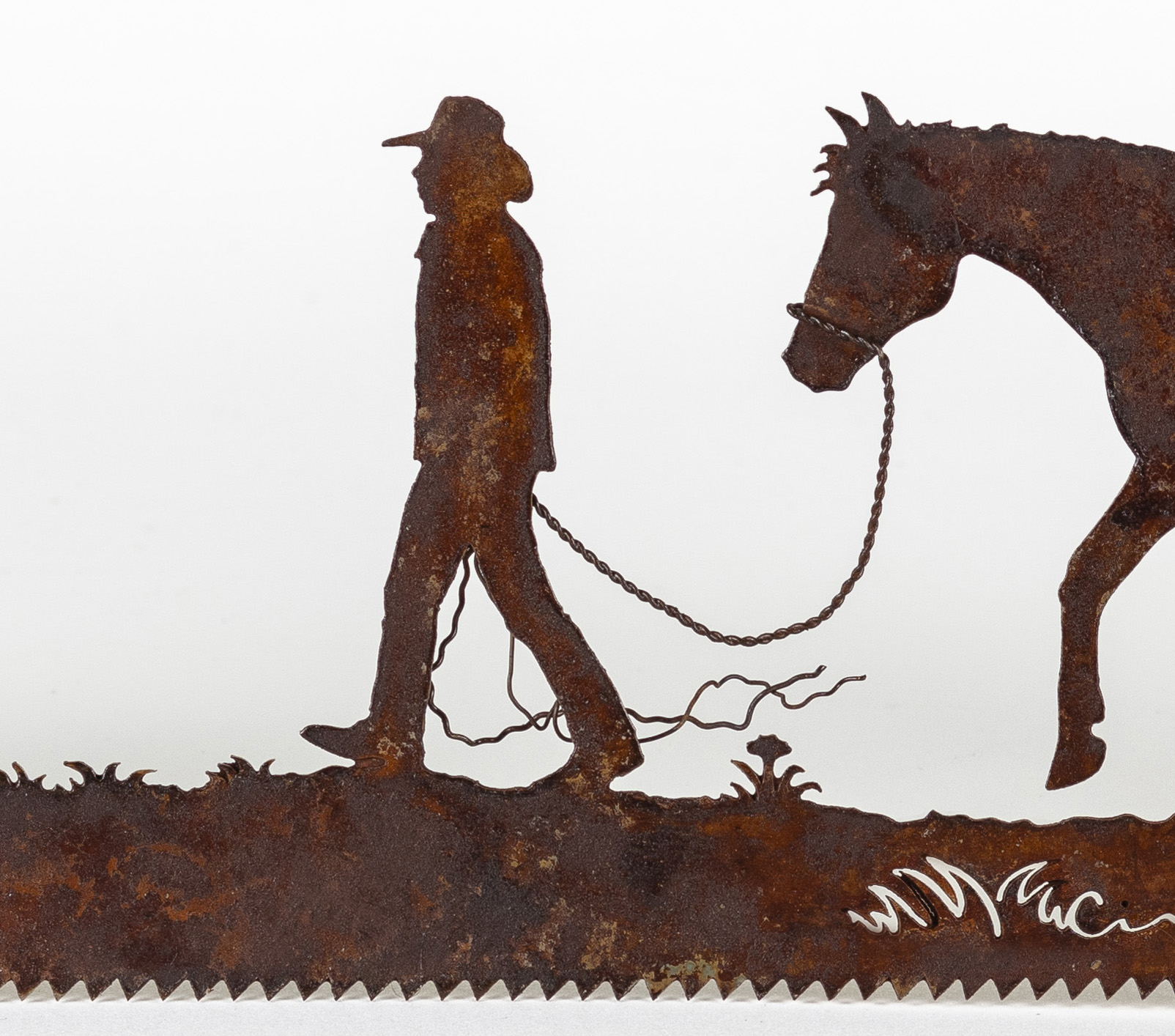 Cowboy-leading-his-horse metal wall saw art