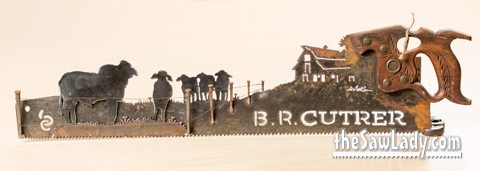 Vintage Brahman bulls hand cut metal hand saw wall art with natural patina rustic ranch decor