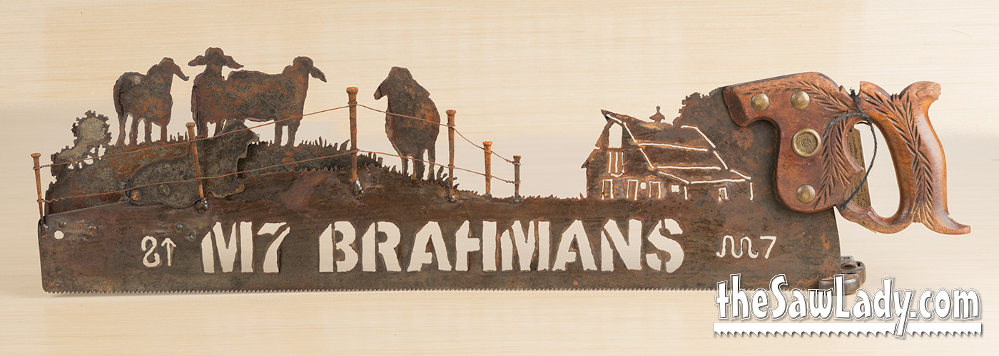 Vintage Brahman bulls hand cut metal hand saw wall art with natural patina rustic ranch decor