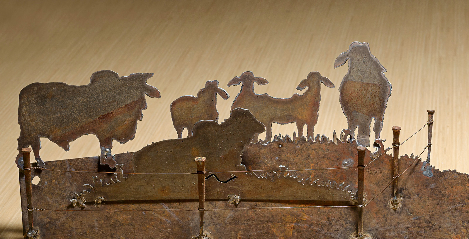 Vintage Brahman bulls hand cut metal hand saw wall art with natural patina rustic ranch decor