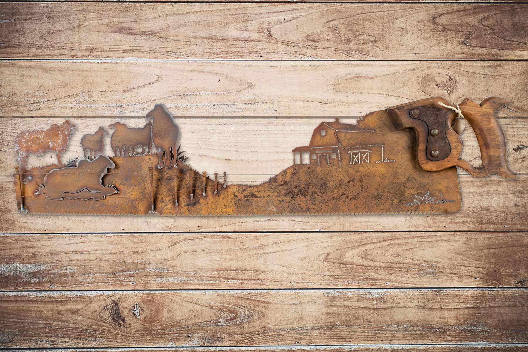 Vintage Brahman bulls hand cut metal hand saw wall art with natural patina rustic ranch decor