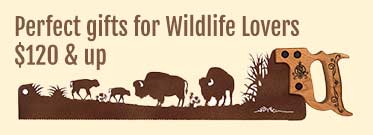 Wildlife themed saw art with animals like deer, moose, and bison